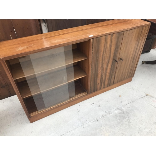 623 - A TEAK CABINET WITH TWO SLIDING GLASS DOORS AND TWO FURTHER DOORS