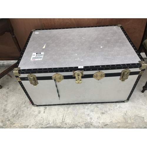 628 - A LARGE ALLOY TRAVEL TRUNK