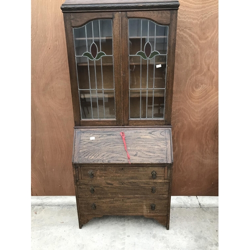 631 - AN OAK BUREAU BOOKCASE WITH FALL FRONT, THREE DRAWERS, AND TWO UPPER LEAD GLAZED DOORS