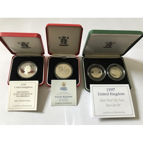 351 - FOUR SILVER PROOF COINS IN CASES WITH CERTIFICATES - A 1997 SET OF TWO 50p PIECES, A 1997 £5 AND A 1... 