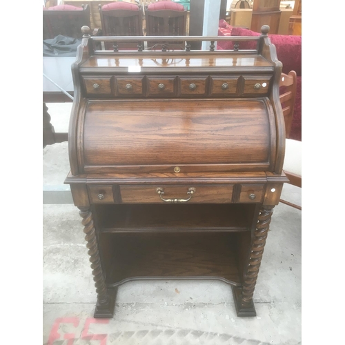 644 - A MAHOGANY DAVENPORT WITH SOLID ROLL TOP, TWO DRAWERS, SLIDE OUT LEATHER TOPPED WRITING SLOPE AND BA... 