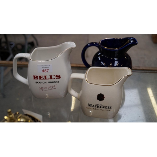 487 - THREE 'WADE' CERAMIC WHISKEY ADVERTISING JUGS TO INCLUDE A BELLS EXAMPLE (3)