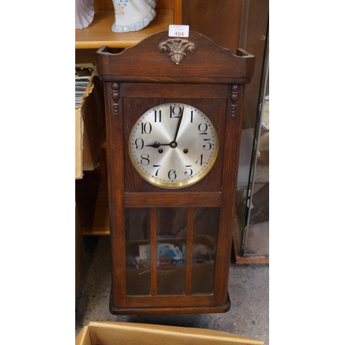 494 - AN EARLY 20TH CENTURY OAK CASED WALL CLOCK