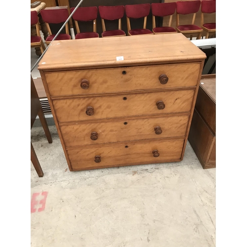 945 - AN OAK AND SATINWOOD CHEST OF FOUR DRAWERS