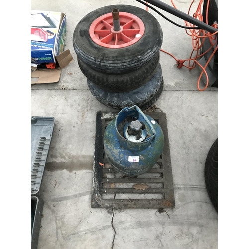 38 - FIVE WHEELBARROW WHEELS AND TYRES, A GRID AND A GAS BOTTLE