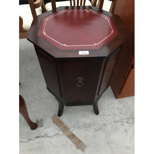 810 - A STRONGBOW OCTAGONAL MAHOGANY DRUM TABLE WITH RED LEATHER TOP AND SINGLE DOOR