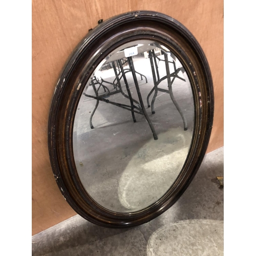 264 - A MAHOGANY FRAMED OVAL WALL MIRROR