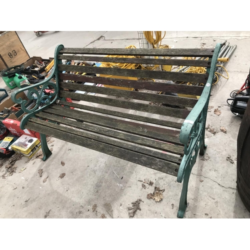 26 - A GREEN WROUGHT IRON AND WOODEN SLATTED GARDEN BENCH