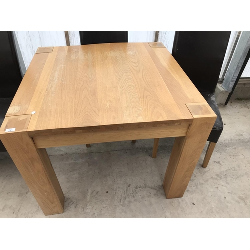 611 - SIX ITEMS - A MODERN SQUARE OAK TABLE, FOUR  OAK AND LEATHERETTE DINING AND A BEECH EFFECT DESK