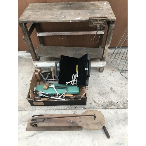 57 - A SMALL WOODEN WORK BENCH WITH WOOD VICE, A VINTAGE FRET SAW AND A BOX OF SPANNERS AND TOOLS