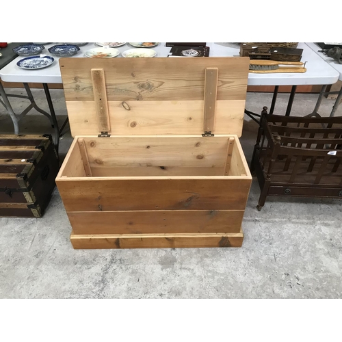 295 - A PINE LIDDED BLANKET BOX MADE FROM CHURCH PEW BOARDS