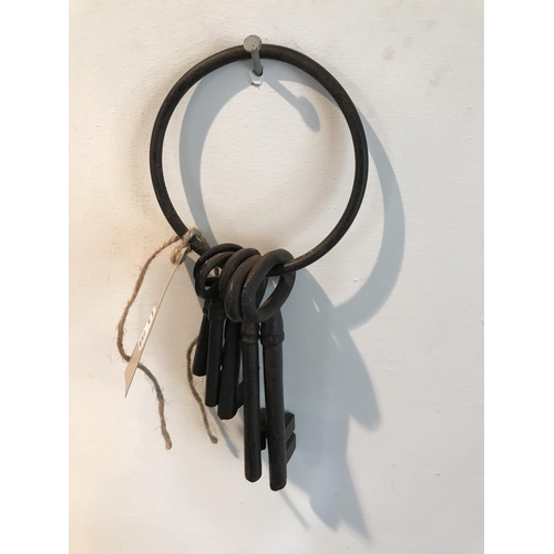 263 - FIVE VINTAGE KEYS ON A LARGE IRON KEYRING