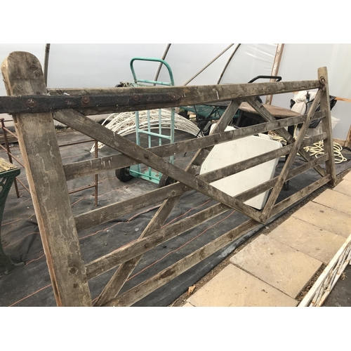 64 - A WOODEN FIVE BAR GATE - WIDTH 304 CM