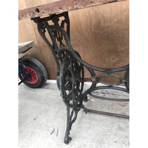 161 - A WOODEN TOP TABLE ON A CAST IRON SEWING MACHINE FRAME 113CM X 60.5CM