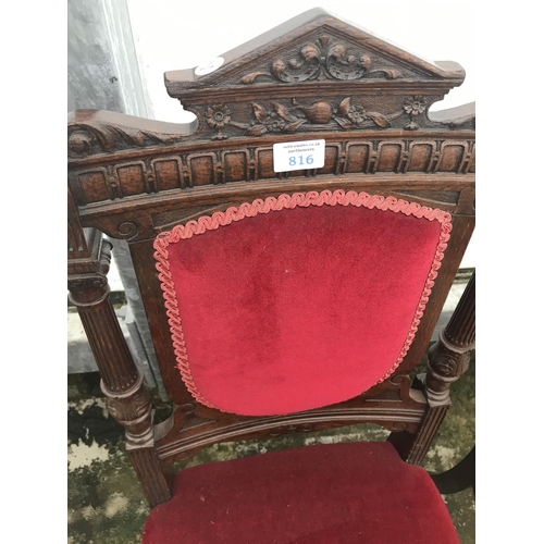 816 - A HEAVILY CARVED MAHOGANY DINING CHAIR WITH RED FABRIC SEAT AND BACK