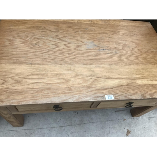 845 - AN OAK COFFEE TABLE WITH TWO DRAWERS