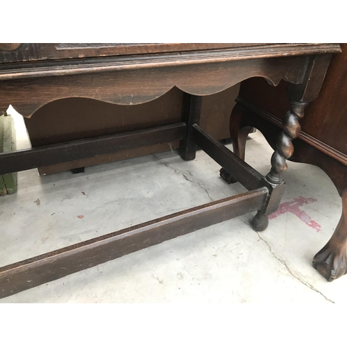 848 - AN OAK SIDEBOARD ON BARLEY TWIST SUPPORTS WITH STRETCHER RAILS WITH TWO DOORS AND TWO DRAWERS WITH B... 