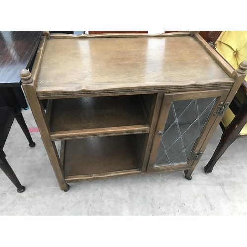 907 - AN OAK DROP END SERVING TABLE AND AN OAK TEA TROLLEY WITH SINGLE LEAD GLAZED DOOR