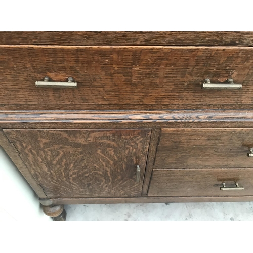 919 - AN OAK SIDEBOARD WITH TWO DOORS AND FOUR DRAWERS