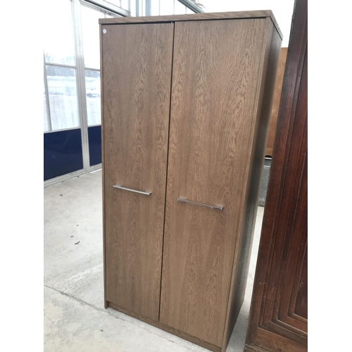 976A - AN OAK VENEERED WARDROBE WITH TWO DOORS