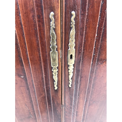 977 - A VINTAGE FRENCH PINE ARMOIRE WARDROBE WITH ELABORATE BRASS ESCUTCHEONS (WOODWORM DAMAGE)