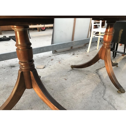 990 - A MAHOGANY DINING TABLE ON TWIN PEDESTAL SUPPORT