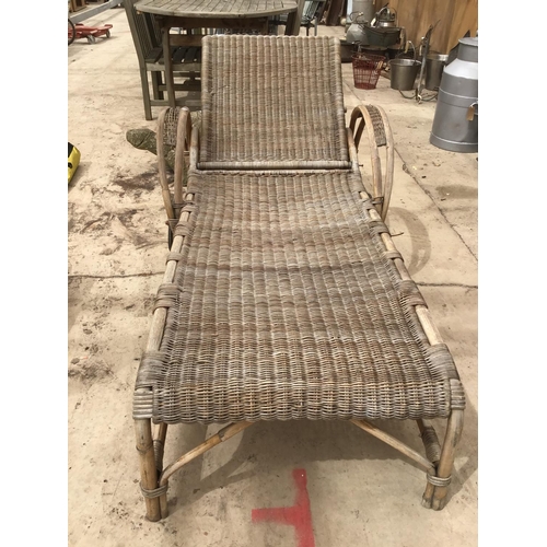 70 - A RATTAN SUN LOUNGER ON WHEELS