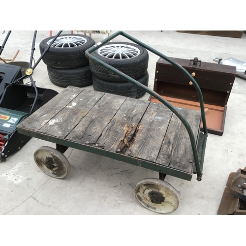 55 - A VINTAGE FOUR WHEELED WOODEN TRUCK WITH METAL WHEELS