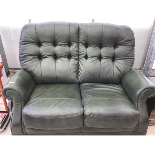 1101 - A GREEN LEATHER BUTTON BACK TWO SEATER SOFA WITH FOOTSTOOL