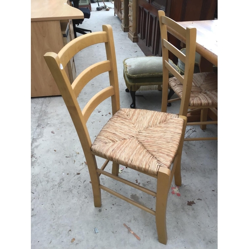 1139 - A MODERN PINE DINING TABLE AND TWO RUSH SEATED CHAIRS