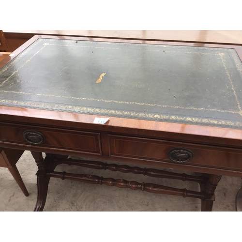 1167 - A MAHOGANY DROP END SOFA TABLE WITH BRASS FEET AND CASTERS AND GREEN LEATHER WRITING SURFACE