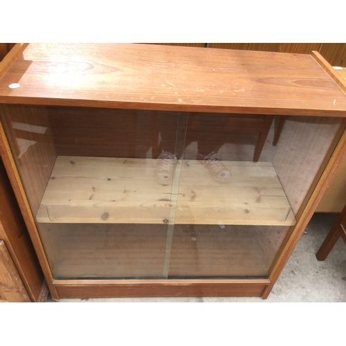 1227 - A PINE SINGLE DOOR CABINET AND TEAK BOOKCASE WITH SLIDING DOORS (2)