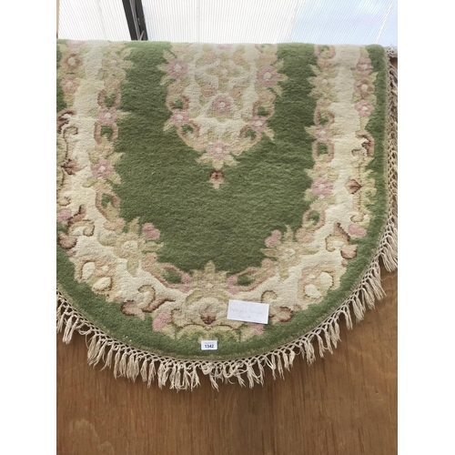 1342 - A GREEN PATTERNED OVAL RUG 144CM X 96CM