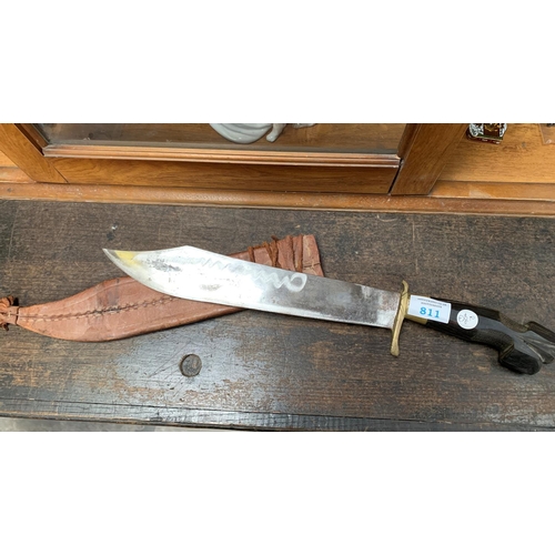 811 - A HAND CARVED PHILIPPINE 1968 NEGRITO BOLO KNIFE WITH LEATHER SLEEVE