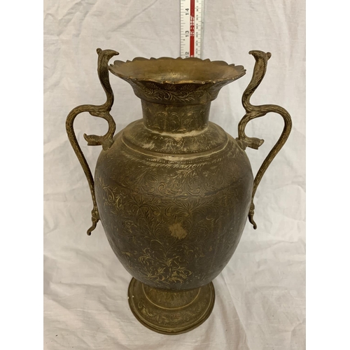 11 - A TALL BRASS VASE WITH COBRA STYLE HANDLES