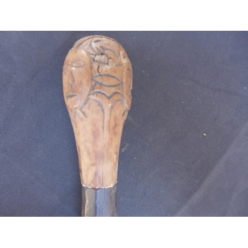 141 - A CARVED WOODEN AFRICAN STICK - LENGTH 128 CM