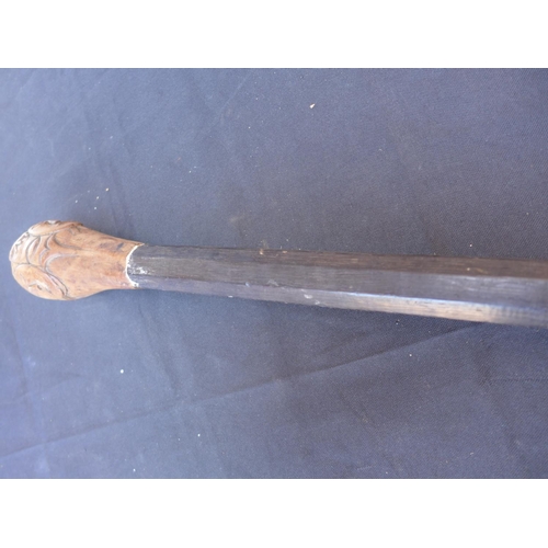 141 - A CARVED WOODEN AFRICAN STICK - LENGTH 128 CM