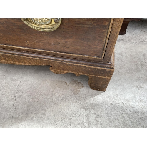 1510 - A GEORGIAN OAK BUREAU ON BRACKET FEET WITH FALL FRONT WITH FOUR DRAWERS HAVING BRASS HANDLES AND ESC... 