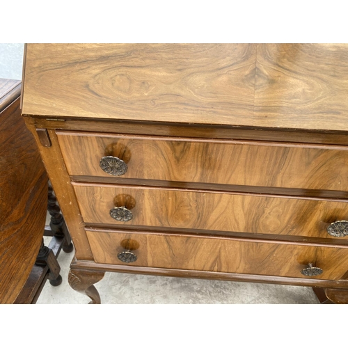 1514 - A WALNUT BUREAU ON CABRIOLE SUPPORTS WITH FALL FRONT, THREE DRAWERS AND INNER RED LEATHER WRITING SU... 