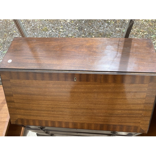 1534 - A MAHOGANY BUREAU ON CABRIOLE SUPPORTS WITH FALL FRONT AND THREE DRAWERS