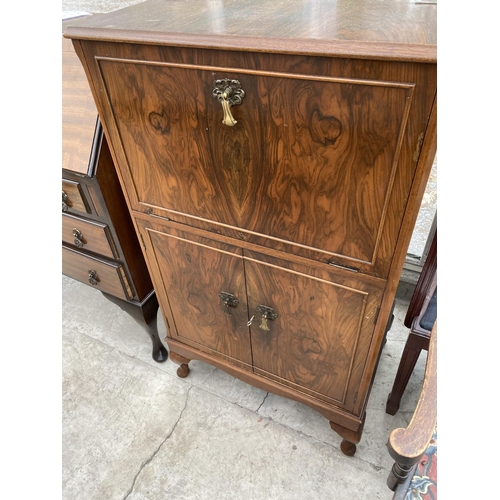 1535 - A WALNUT COCKTAIL CABINET WITH FALL FRONT AND SIMULTANEOUS RAISING TOP, TWO LOWER DOORS AND MIRRORED... 