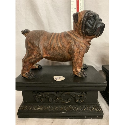 110 - A PAIR OF BULLDOGS ON ORNATE PLINTHS