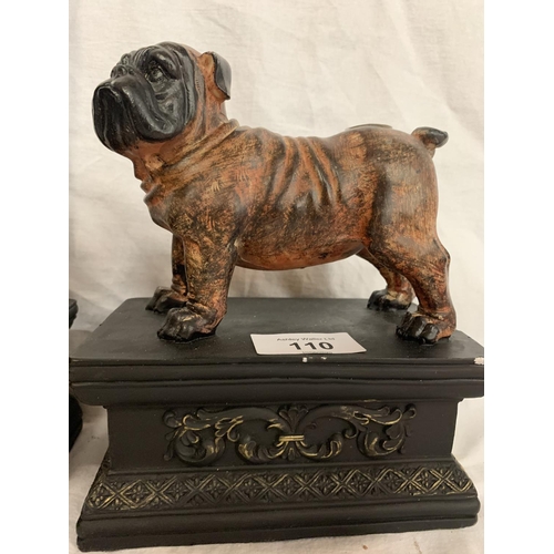 110 - A PAIR OF BULLDOGS ON ORNATE PLINTHS