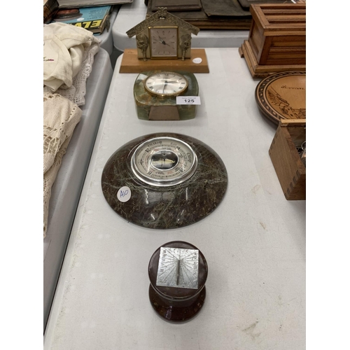 125 - TWO CLOCKS TO INCLUDE A EUROPA ON A WOODEN BASE, AN ONYX EXAMPLE, A BAROMETER AND A MINATURE SUNDIAL