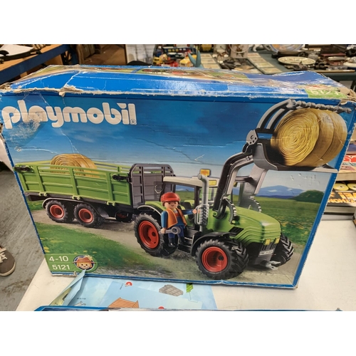 129 - A SPEED BOAT, A COMBINE HARVESTER, A POLICE VAN AND TWO PLAYMOBIL KITS OF A PIRATE SHIP AND TRACTOR ... 