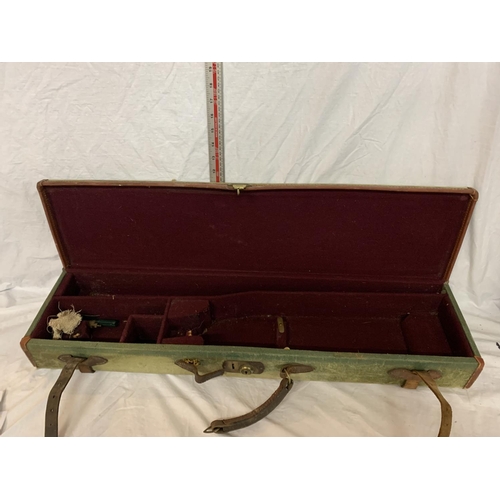 191 - A GREEN CANVAS GUN CASE WITH LEATHER STRAPS (HANDLE A/F)