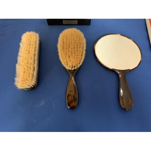 220 - A TORTOISHELL EFFECT THREE PIECE DRESSING TABLE SET COMPRSING OF A  MIRROR AND TWO BRUSHES AND A PRE... 