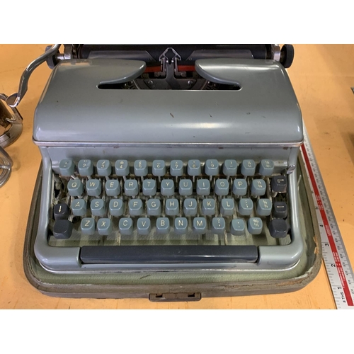 233 - A VINTAGE CASED BLUE BIRD TYPE WRITER