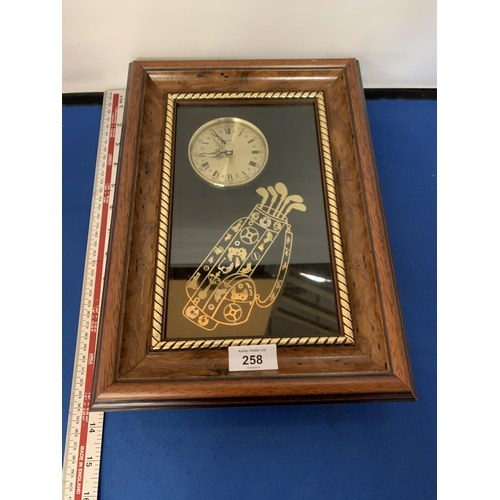 258 - A FRAMED CLOCK WITH A GOLF BAG AND CLUBS DECORATION