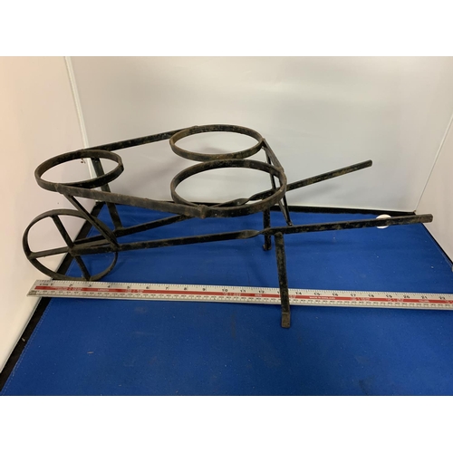 268 - A WROUGHT IRON PLANT POT HOLDER IN THE FORM OF A WHEELBARROW